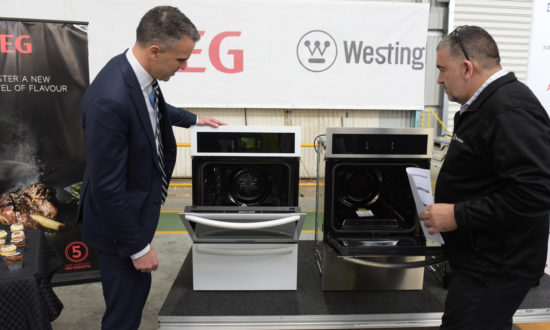 South Australia's Premier Peter Malinauskis and Electrolux's Phil Saloniklis inspecting the first ovens manufactured in Adelaide and destined for the United States